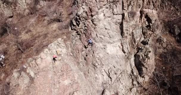 Skupina lidí se zabývá lezení po skalách. — Stock video