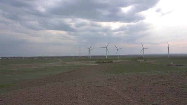 Windmills in the steppe on the lake shore. — Stock Video