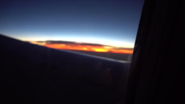 Zonsondergang vanuit het vliegtuigraam. — Stockvideo