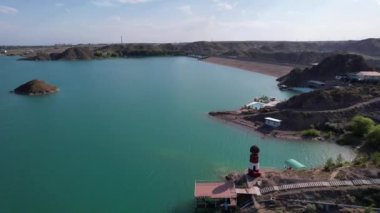 Gölün kıyısında beyaz ve kırmızı deniz feneri