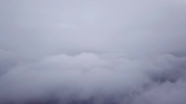Flying among several layers of clouds over city. — Stock Video