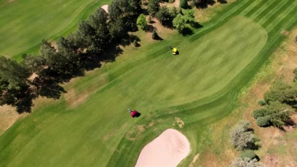Вид сверху на игру на зеленом поле для гольфа — стоковое видео