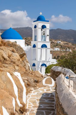 Chora, Ios Island, Greece- 20 September 2020: View of the Church of Virgin Mary of the Cliff. White building on the hill. Beautiful, sunny day.