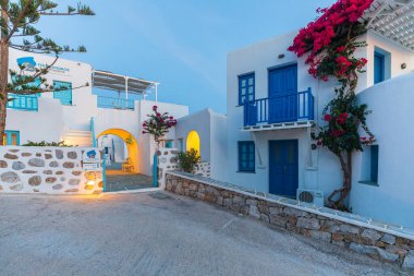 Folegandros Adası, Yunanistan - 23 Eylül 2020: Chora 'da dar bir ara sokak, eski kasaba. Günbatımında karakteristik Yunan binaları.