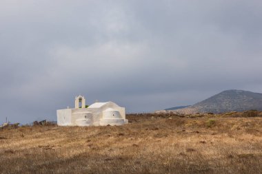 Traditional white chapel, a small church around the hill, Folegandros Island, Greece.