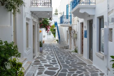 Parikia, Paros Adası, Yunanistan - 26 Eylül 2020: Eski şehrin dar sokakları. Geleneksel, geniş mimari ve beyaz eklemli taş bir yol..
