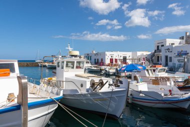 Naoussa, Paros Adası, Yunanistan - 27 Eylül 2020: Limana demirlemiş tekne ve yelkenli gemi. Güneşte kurutulmuş ahtapot. Küçük balıkçı kasabası.