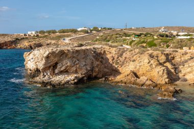 Paros adasının Rocky Sahili. Arka planda beyaz, geleneksel bir bina. Yunanistan.