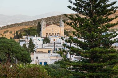 View of the Saint Ioannis Kleidonias in the center of Lefkes. High building against the backdrop of the mountains, Paros island, Greece. clipart