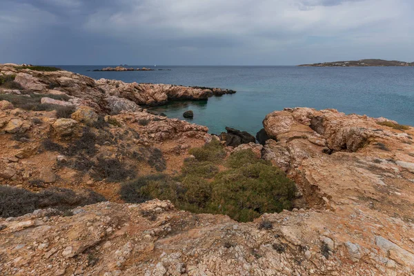 Rocky, Aegean coast on the west side of the Paros Island. Hills around. Greece.