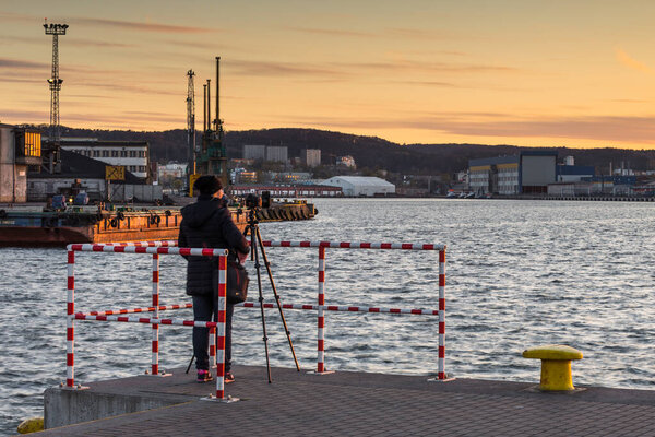 Gdynia, Poland - 22 April 2016: A woman taking photos in the Port of Gdynia, French Quay.