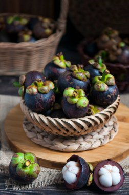 Delicious fresh mangosteen on the rustic wooden table