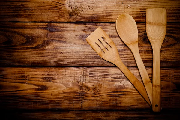 Wooden spoon on old wooden burned table or board for background. — Stock Photo, Image