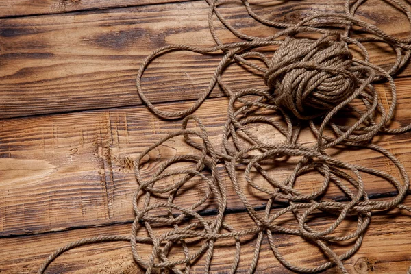 Rope on old wooden burned table or board for background — Stock Photo, Image