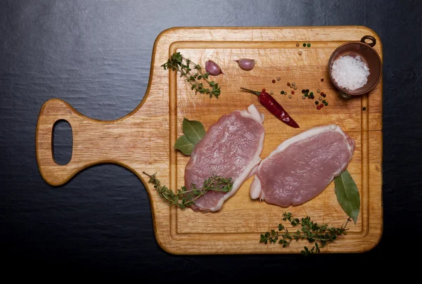 Bistecche di carne fresca su tagliere di legno leggero — Foto Stock