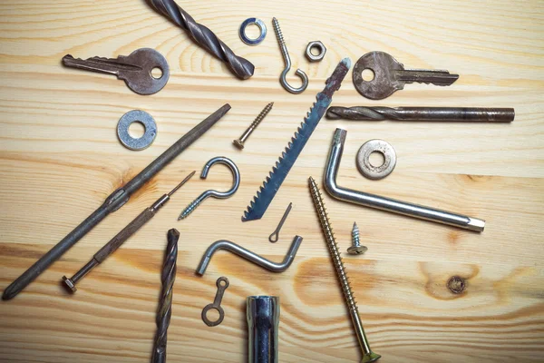 The contents of the old toolbox on light wooden background. Top