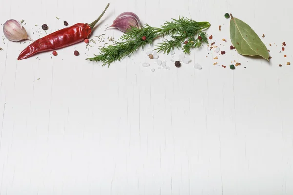 Herbs and spices on white wooden background. Space for text — Stock Photo, Image