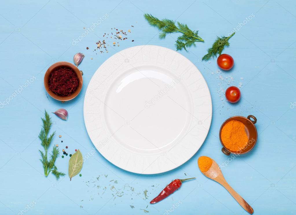 Herbs and spices on light blue wooden background