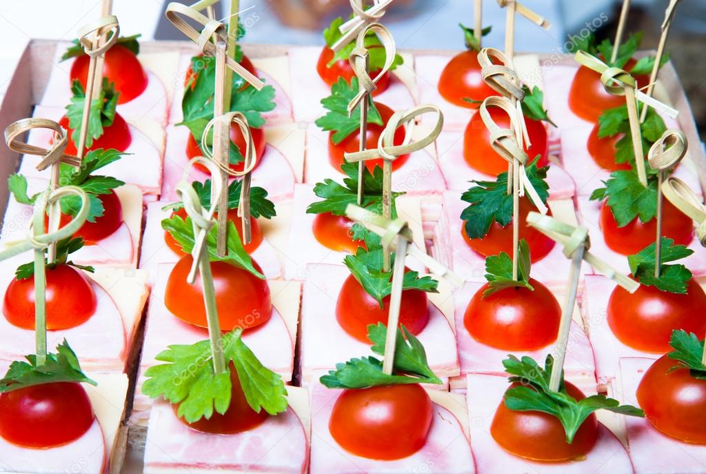 Set of small snacks canape with cherry tomatoes, cheese and ham 