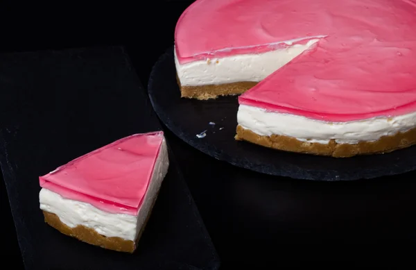 Fresh homemade cheesecake with pink jelly — Stock Photo, Image