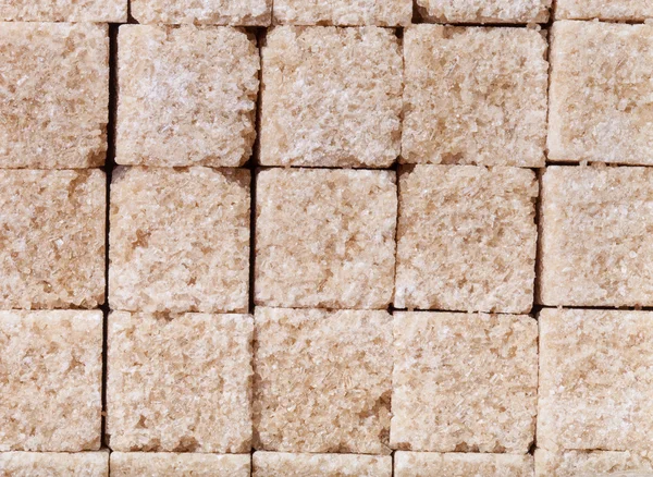 Kahverengi şeker için arka plan dokusu olarak parçaları — Stok fotoğraf