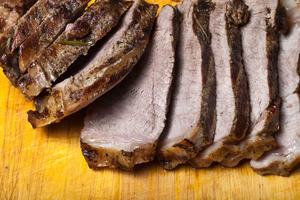 Large piece of fresh beef meat prepared on a grill pan on light — Stock Photo, Image