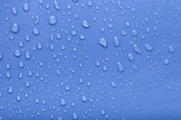 Dops de água em um fundo de cor. Azul. Tonificado — Fotografia de Stock