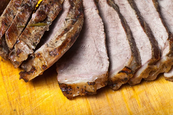 Large piece of fresh beef meat prepared on a grill pan on light — Stock Photo, Image