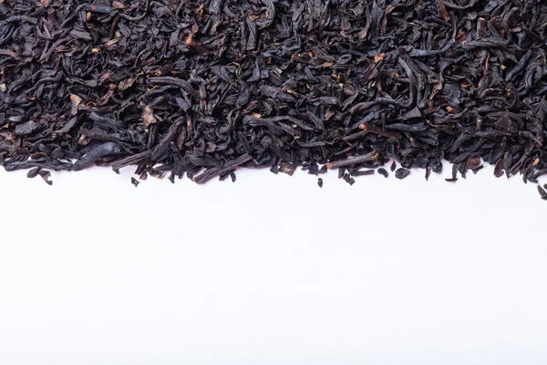 Hojas de té negro seco como textura para el fondo — Foto de Stock
