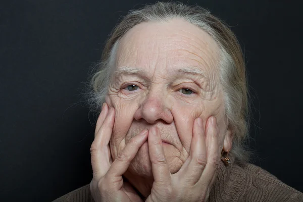 Portrait of elderly woman on dark background — Stock Photo, Image