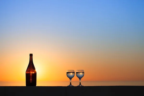 Bouteille et verres de vigne blanche avec reflets de maisons et — Photo