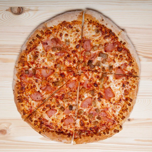 Fresh homemade pizza on light wooden table — Stock Photo, Image