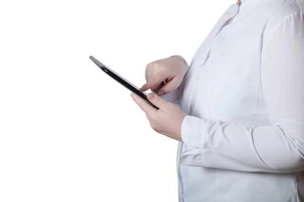 A woman in a white uniform robe with electronic device in her ha Royalty Free Stock Images