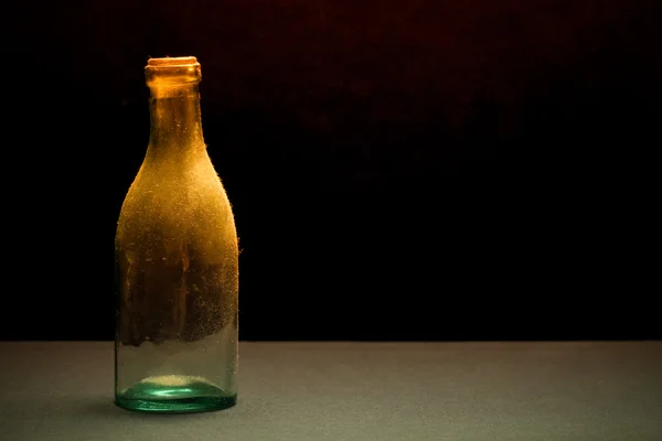 Ancient dust bottle on dark background. Selective focus. Shallow Stock Picture