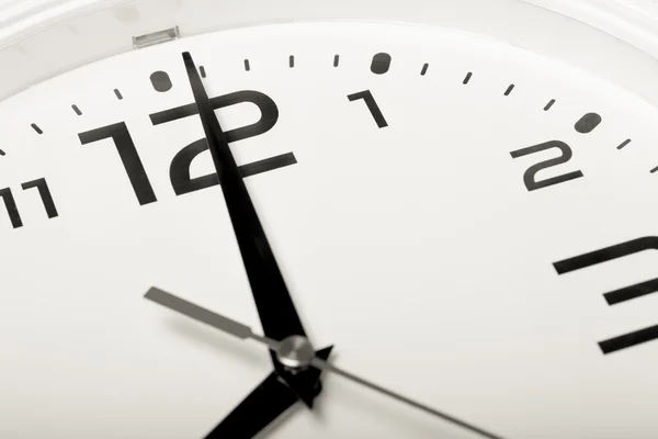 Белые настенные часы с черными стрелками Выборочный фокус. Шаллоу-деп — стоковое фото