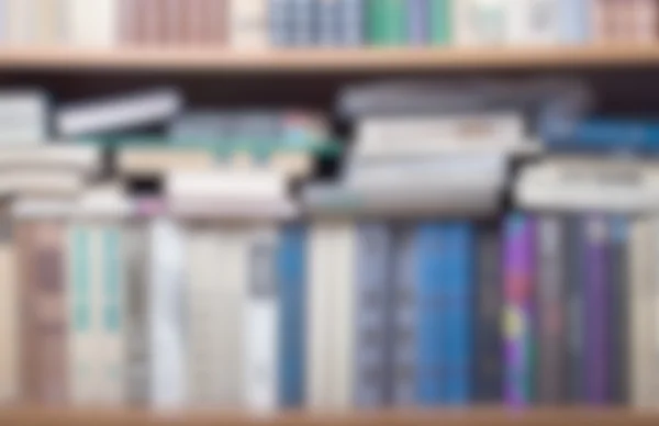 Shelves with old books. Defocused