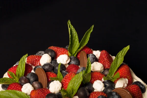 Biscuit homemade cake with cream and berries on black background — Stock Photo, Image