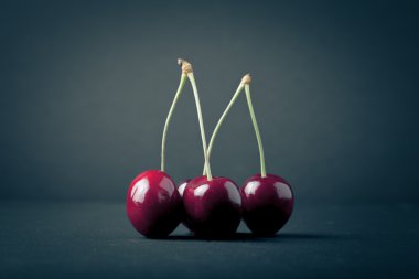 Cherry berries on black background. Selective focus. Shallow dep clipart