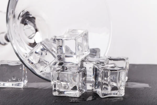 Ice cubes and martini glass on white background — Stock Photo, Image