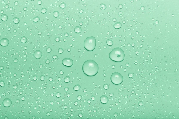 Drops of water on a color background. Green. Toned — Stock Photo, Image