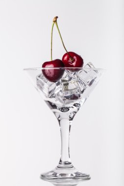 Beyaz zemin üzerinde bir martini cam kiraz çilek