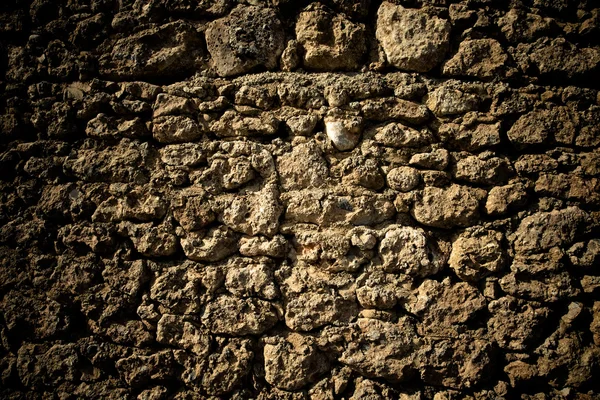 Old stone wall with cracks. Toned — Stock Photo, Image