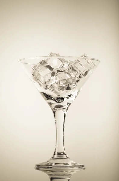 Ice cubes and martini glass on white background. Toned — Stock Photo, Image