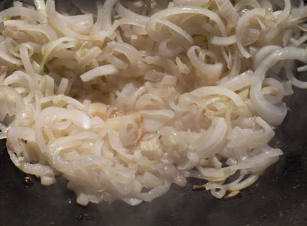Lot of chopped onion on a frying pan. Selective focus — Stock Photo, Image