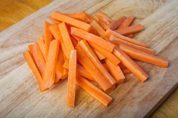 Zanahorias en rodajas en una tabla de cortar de madera —  Fotos de Stock