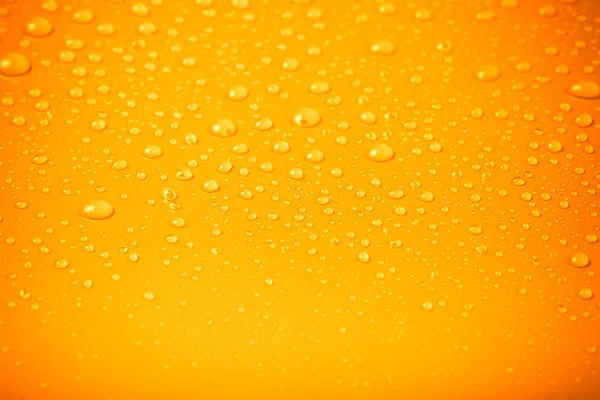 Drops of water on a color background. Orange. Shallow depth of f — Stock Photo, Image