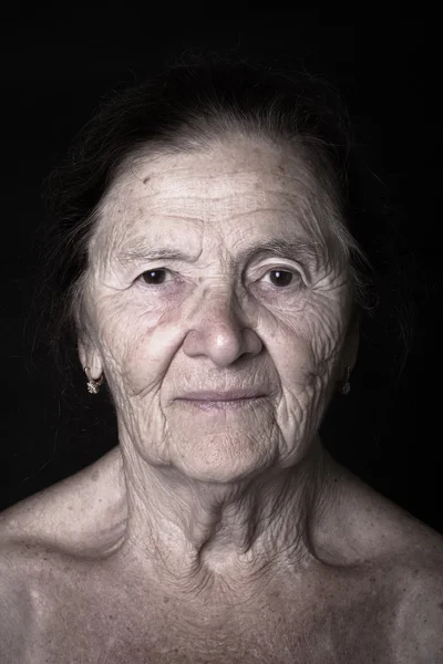 Portrait of elderly woman. Attentiveness. Toned — Stock Photo, Image