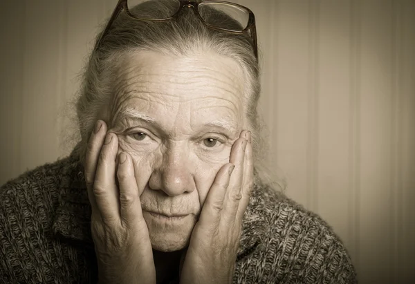 Portrait of elderly woman in glasses. Toned — Stock Photo, Image