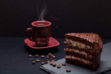 Parça çikolatalı kek ve kahve blac kayrak plaka üzerinde