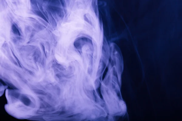 Cloud of smoke on black background. Selective focus. Toned — Stock Photo, Image